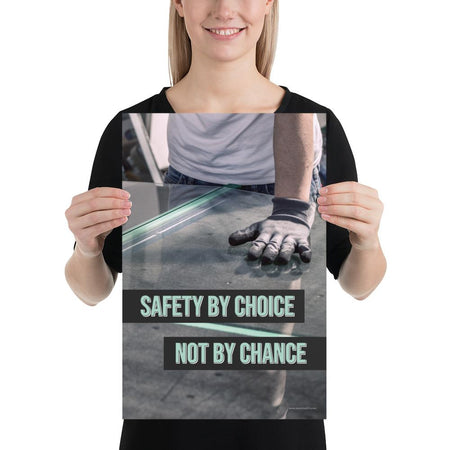 A workplace safety poster showing a close-up of a worker's hands grabbing panes of glass with gloves on with the slogan safety by choice not by chance.