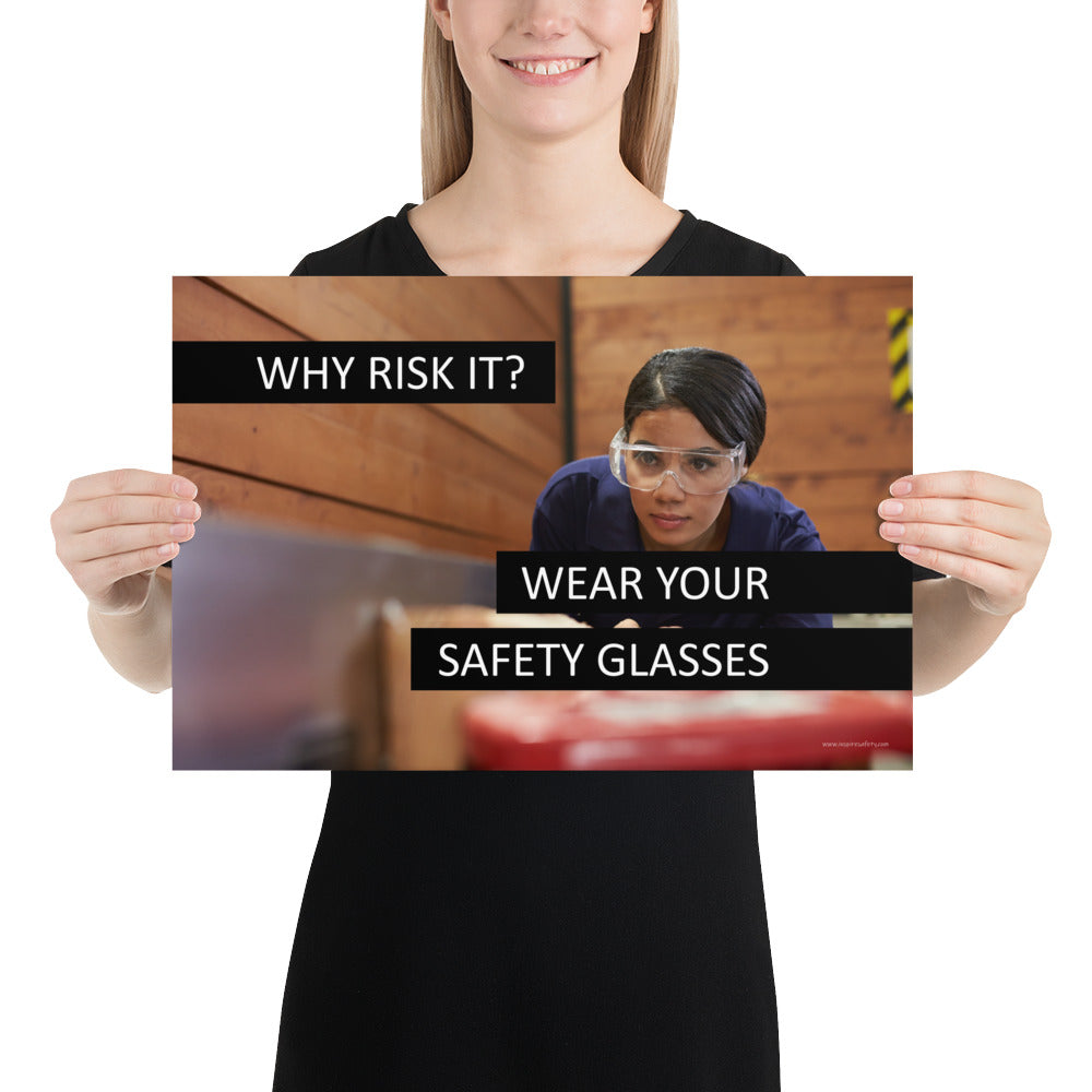 A safety poster showing a woman using a table saw to cut wood wearing safety glasses with the slogan "Why Risk It? Wear Your Safety Glasses."