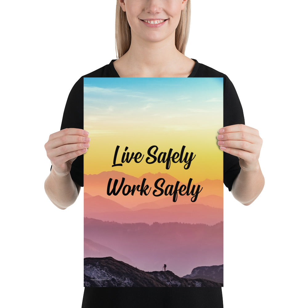 A safety poster showing a mountain range with a beautiful gradient in the sky of blue, yellow, and pink with the safety slogan "Live Safely Work Safely."