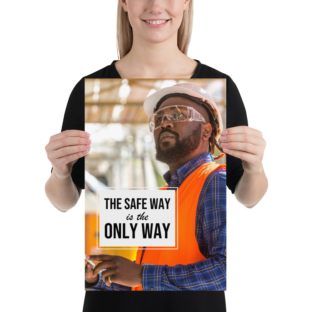 A construction worker in an orange vest, hard hat, and safety glasses working intently with the slogan "The safe way is the only way."