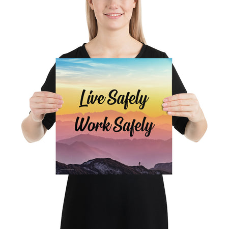 A safety poster showing a mountain range with a beautiful gradient in the sky of blue, yellow, and pink with the safety slogan "Live Safely Work Safely."