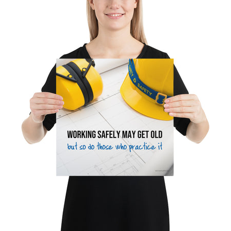 A construction safety poster showing yellow ear muffs and a hard hat resting on blueprints with the slogan "Working safely may get old, but so do those who practice it."