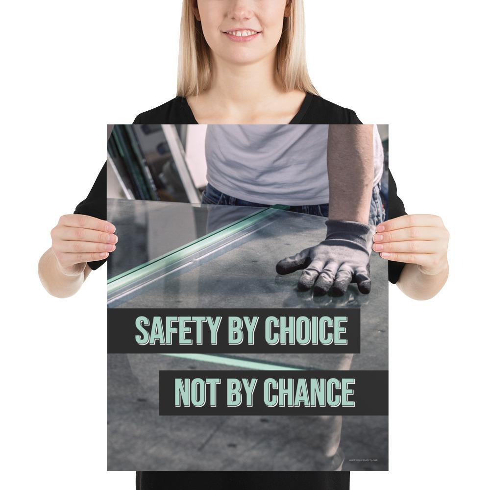 A workplace safety poster showing a close-up of a worker's hands grabbing panes of glass with gloves on with the slogan safety by choice not by chance.