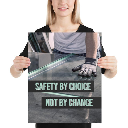 A workplace safety poster showing a close-up of a worker's hands grabbing panes of glass with gloves on with the slogan safety by choice not by chance.