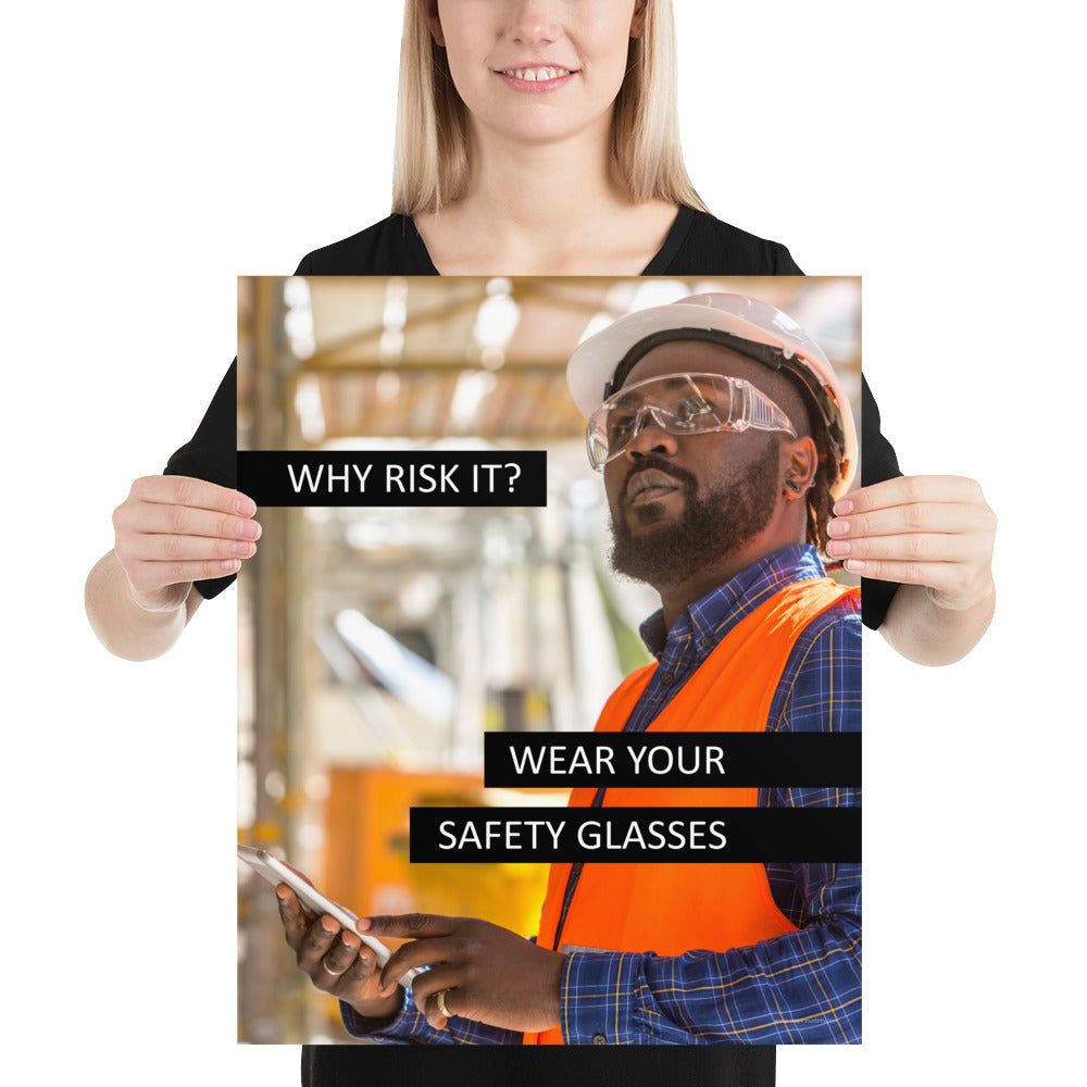 A safety poster showing a man in a reflective vest, hard hat, and safety glasses working with the slogan "Why risk it? Wear your safety glasses."