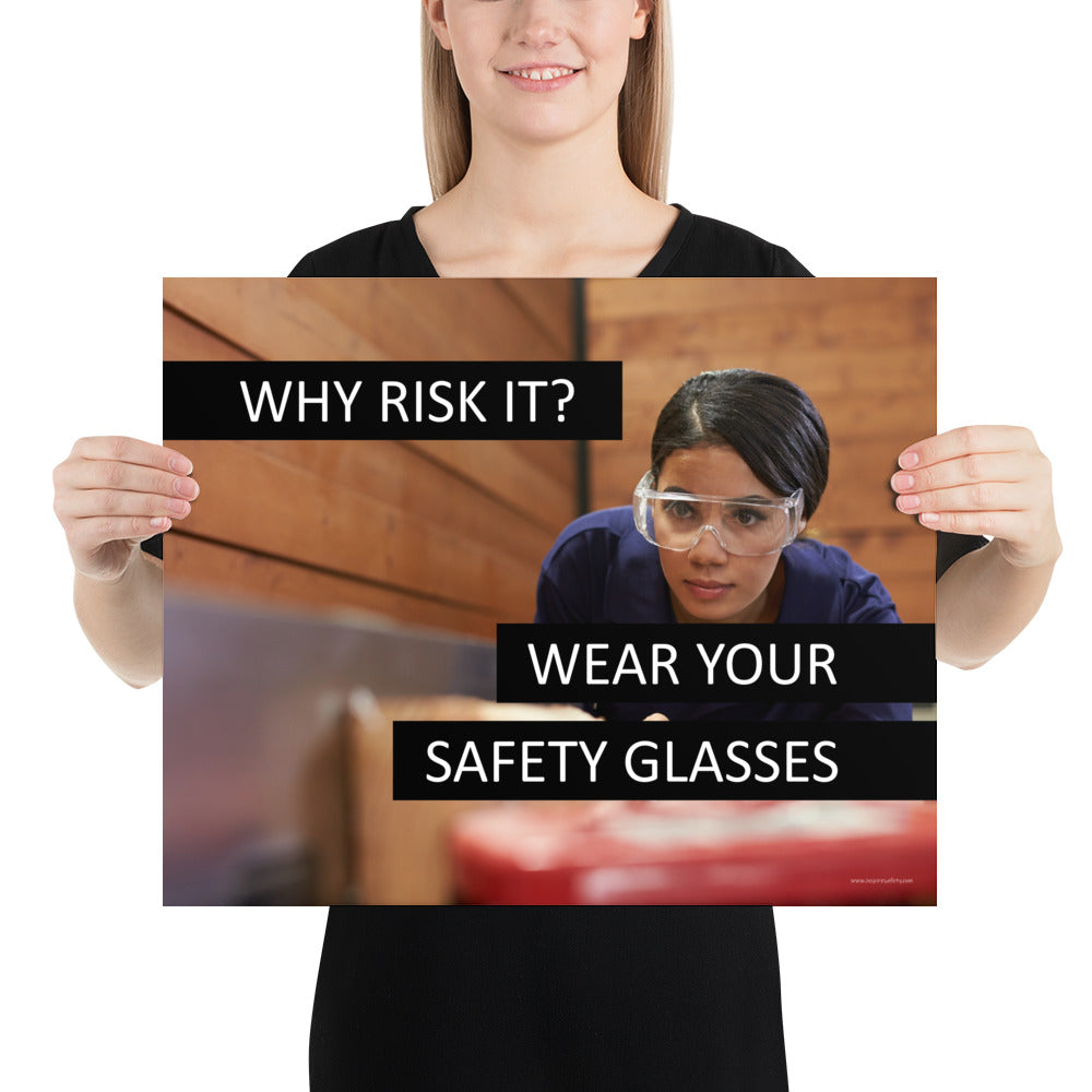 A safety poster showing a woman using a table saw to cut wood wearing safety glasses with the slogan "Why Risk It? Wear Your Safety Glasses."