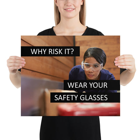 A safety poster showing a woman using a table saw to cut wood wearing safety glasses with the slogan "Why Risk It? Wear Your Safety Glasses."