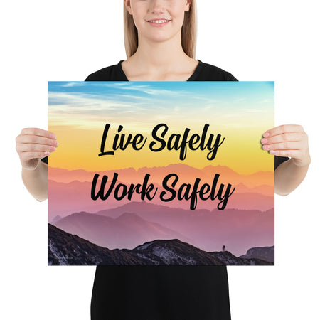 A safety poster showing a mountain range with a beautiful gradient in the sky of blue, yellow, and pink with the safety slogan "Live Safely Work Safely."
