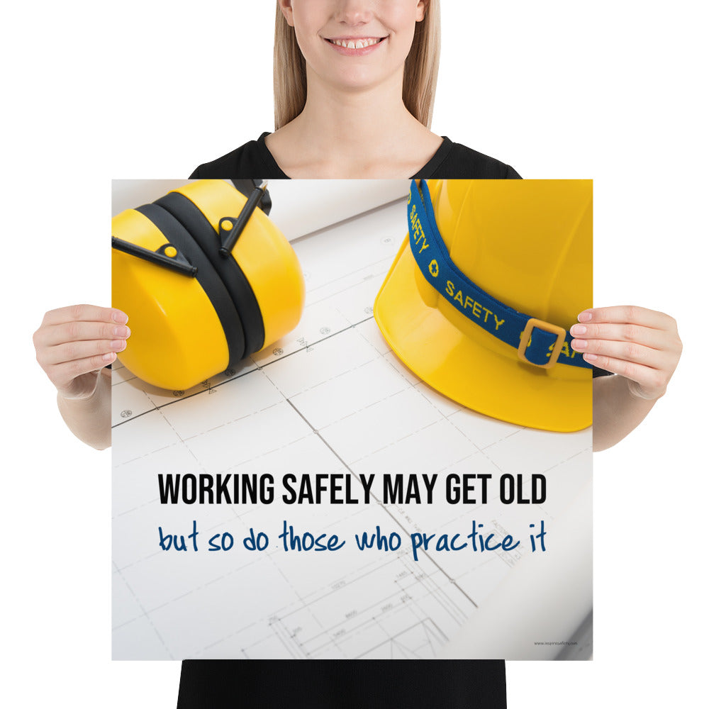A construction safety poster showing yellow ear muffs and a hard hat resting on blueprints with the slogan "Working safely may get old, but so do those who practice it."