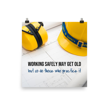 A construction safety poster showing yellow ear muffs and a hard hat resting on blueprints with the slogan "Working safely may get old, but so do those who practice it."