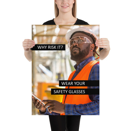 A safety poster showing a man in a reflective vest, hard hat, and safety glasses working with the slogan "Why risk it? Wear your safety glasses."