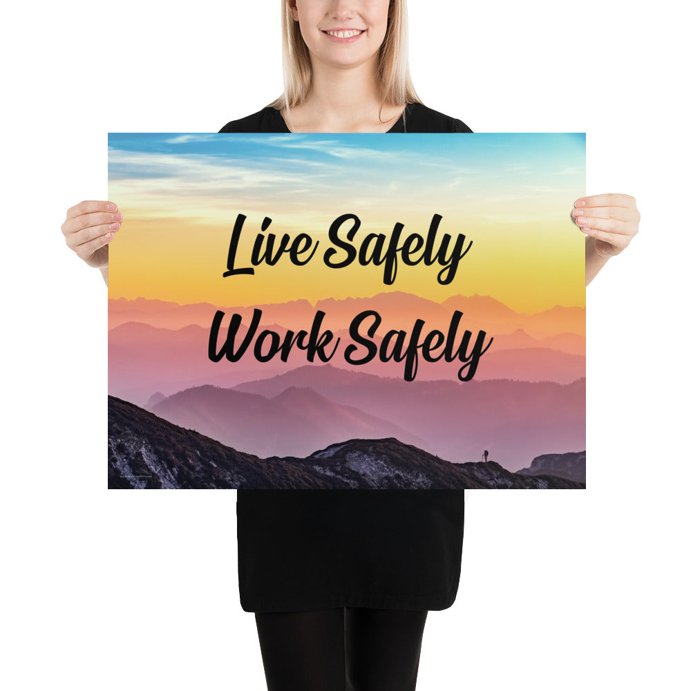 A safety poster showing a mountain range with a beautiful gradient in the sky of blue, yellow, and pink with the safety slogan "Live Safely Work Safely."