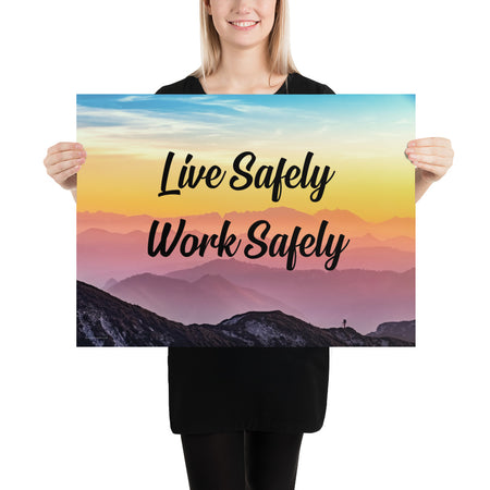 A safety poster showing a mountain range with a beautiful gradient in the sky of blue, yellow, and pink with the safety slogan "Live Safely Work Safely."