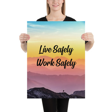 A safety poster showing a mountain range with a beautiful gradient in the sky of blue, yellow, and pink with the safety slogan "Live Safely Work Safely."