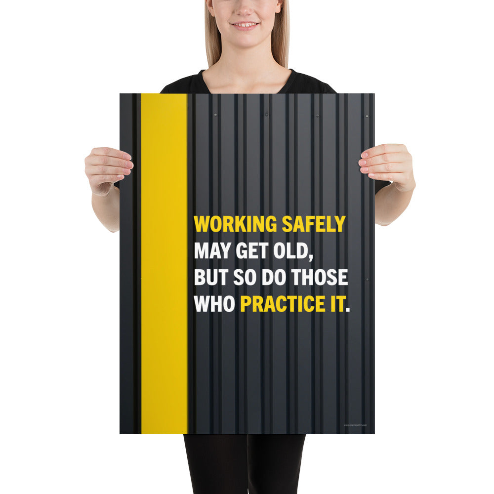 A construction safety poster showing a black metal wall with a yellow stripe with the slogan "Working safely may get old, but so do those who practice it."