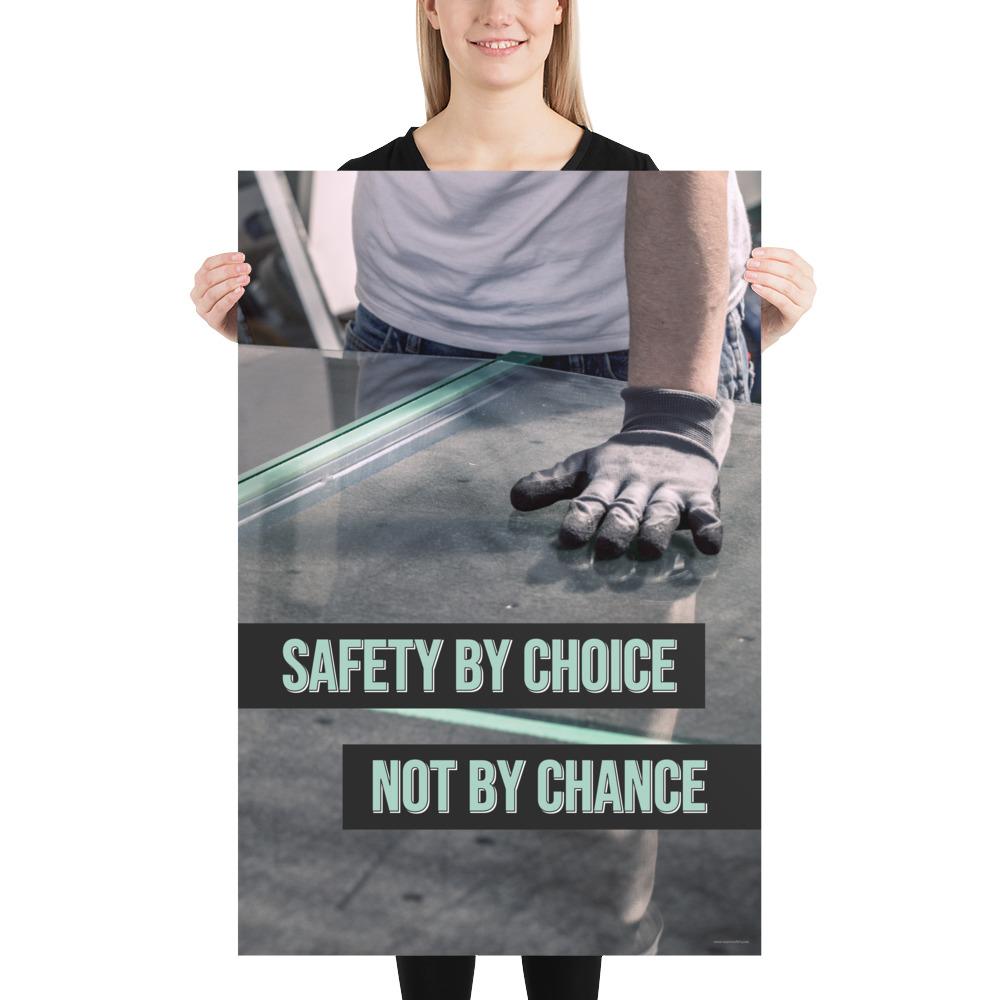 A workplace safety poster showing a close-up of a worker's hands grabbing panes of glass with gloves on with the slogan safety by choice not by chance.