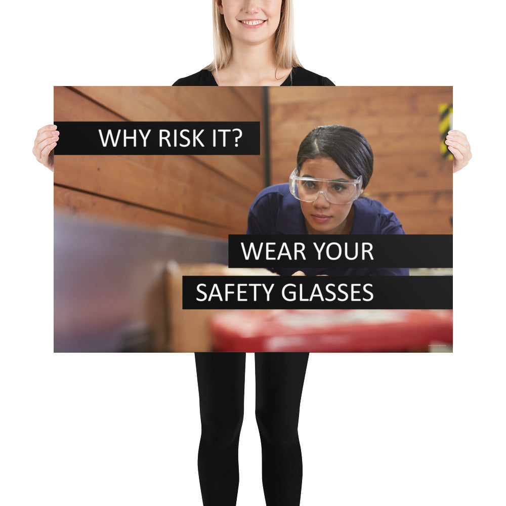 A safety poster showing a woman using a table saw to cut wood wearing safety glasses with the slogan "Why Risk It? Wear Your Safety Glasses."