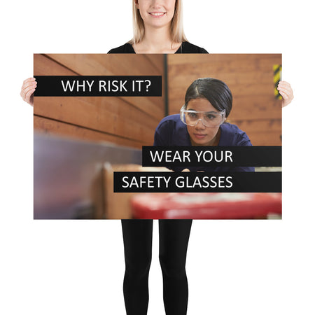 A safety poster showing a woman using a table saw to cut wood wearing safety glasses with the slogan "Why Risk It? Wear Your Safety Glasses."