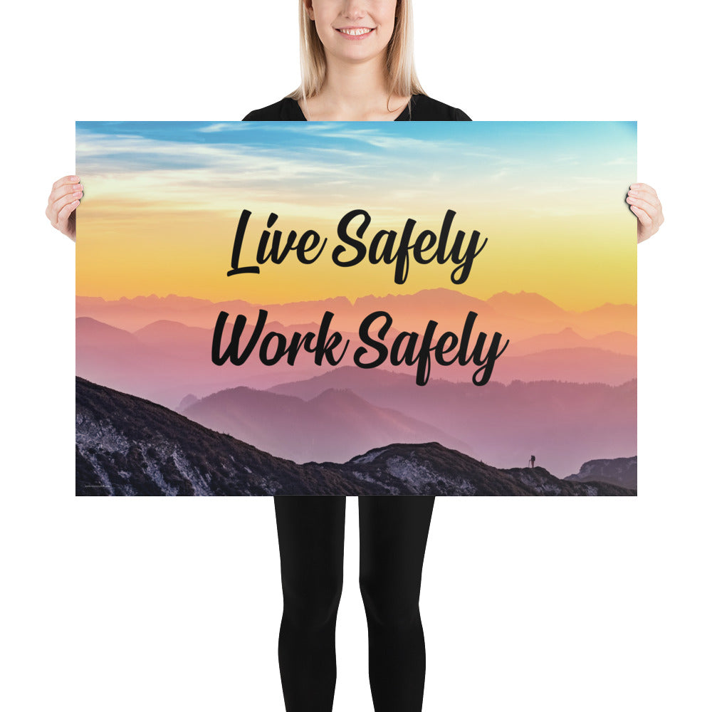 A safety poster showing a mountain range with a beautiful gradient in the sky of blue, yellow, and pink with the safety slogan "Live Safely Work Safely."