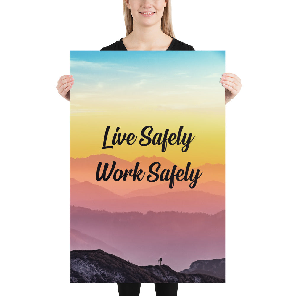 A safety poster showing a mountain range with a beautiful gradient in the sky of blue, yellow, and pink with the safety slogan "Live Safely Work Safely."