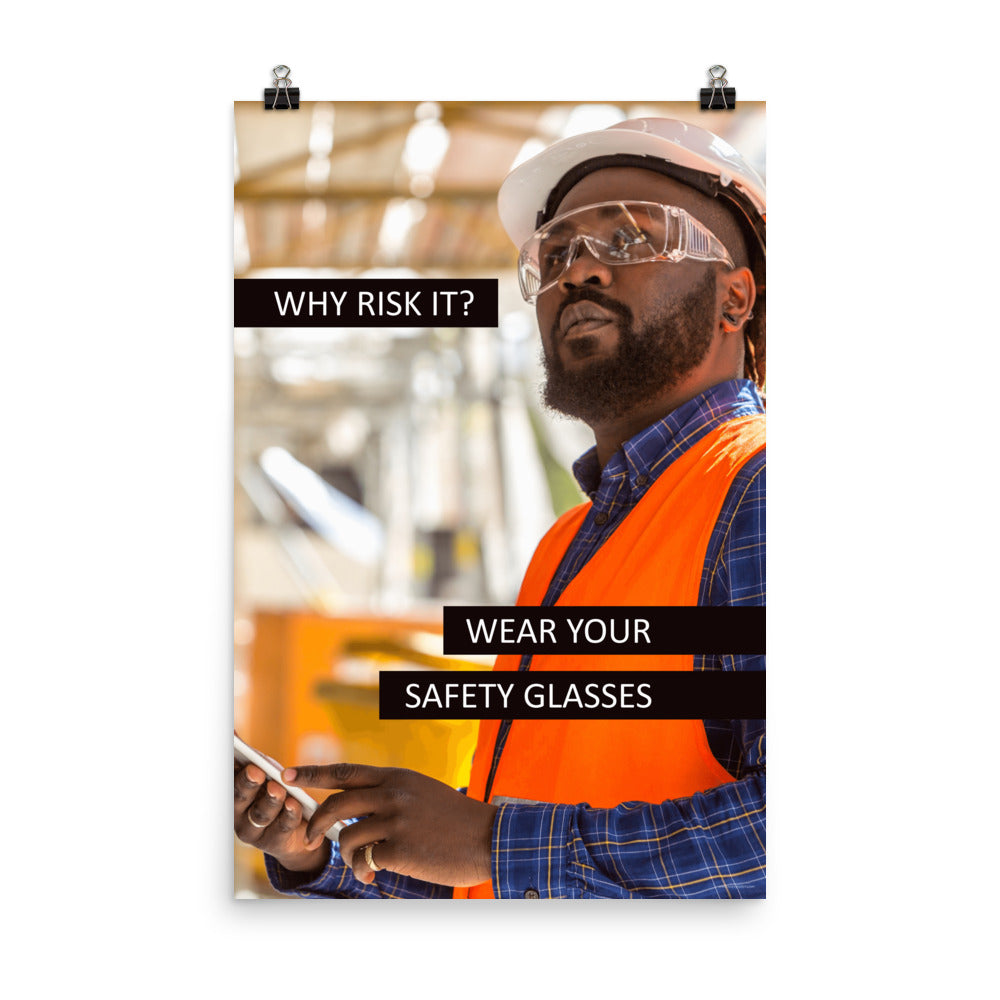 A safety poster showing a man in a reflective vest, hard hat, and safety glasses working with the slogan "Why risk it? Wear your safety glasses."