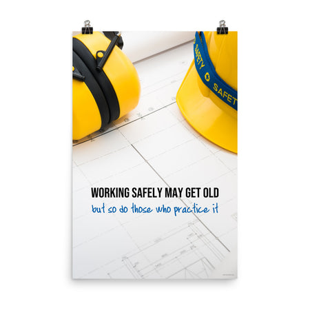 A construction safety poster showing yellow ear muffs and a hard hat resting on blueprints with the slogan "Working safely may get old, but so do those who practice it."