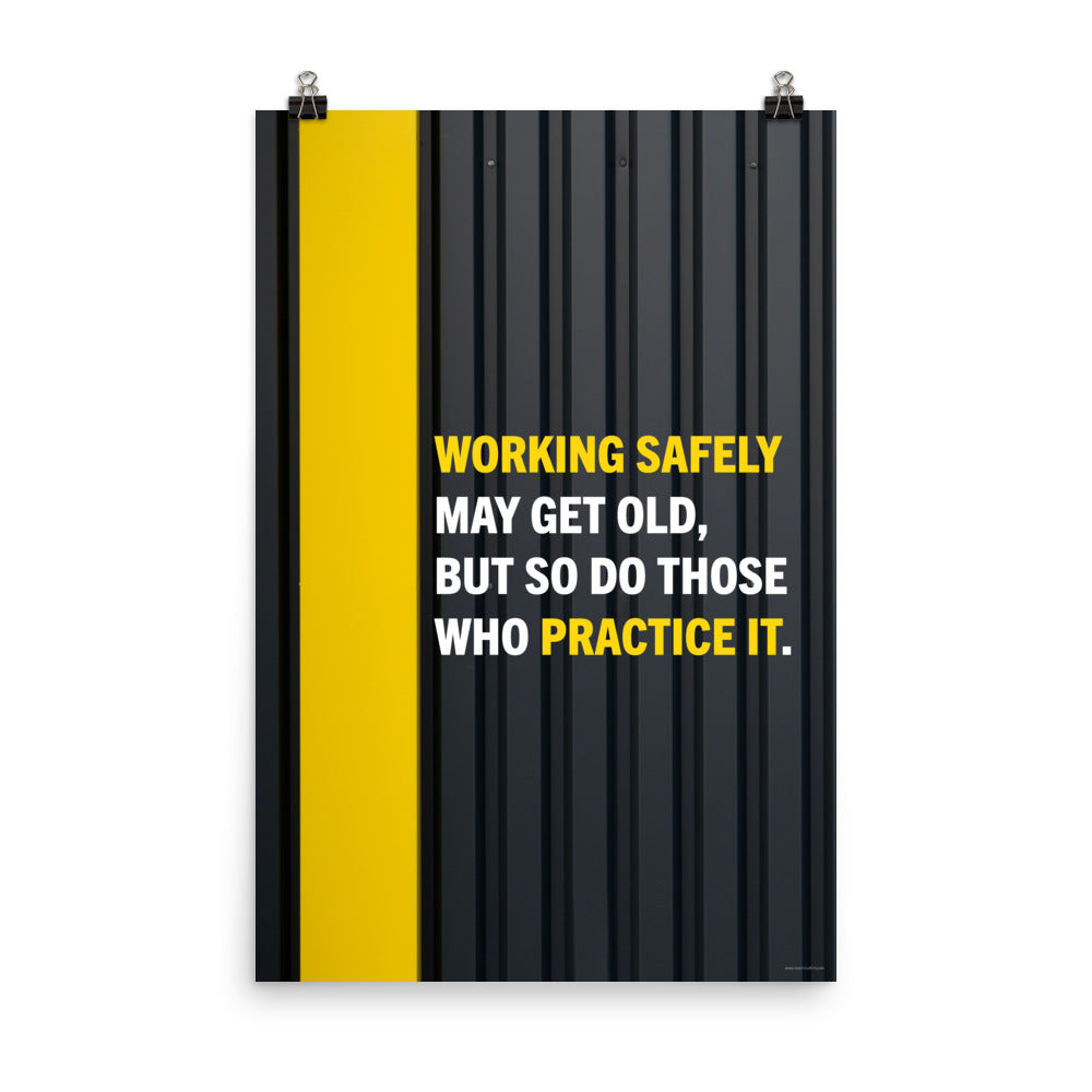 A construction safety poster showing a black metal wall with a yellow stripe with the slogan "Working safely may get old, but so do those who practice it."
