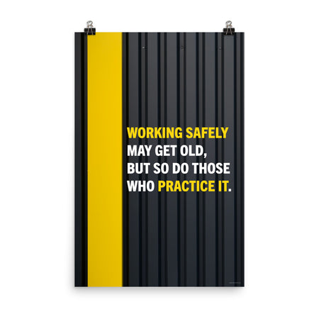 A construction safety poster showing a black metal wall with a yellow stripe with the slogan "Working safely may get old, but so do those who practice it."