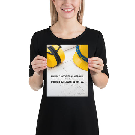 A safety poster showing a yellow hard hat and yellow ear muffs on blueprints with a safety quote by Johann Wolfgang von Goethe that says "Knowing is not enough, we must apply. Willing is not enough, we must do."
