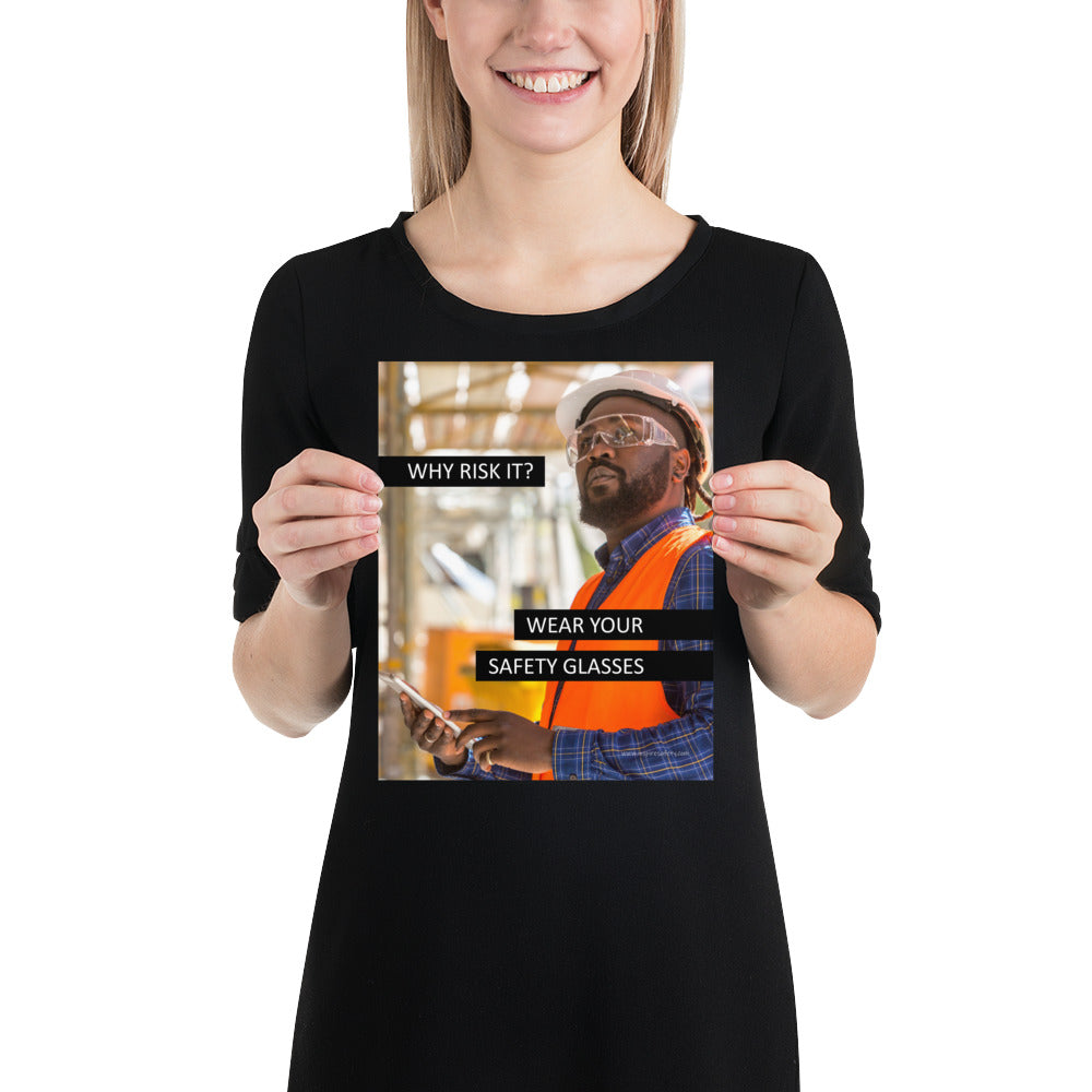 A safety poster showing a man in a reflective vest, hard hat, and safety glasses working with the slogan "Why risk it? Wear your safety glasses."