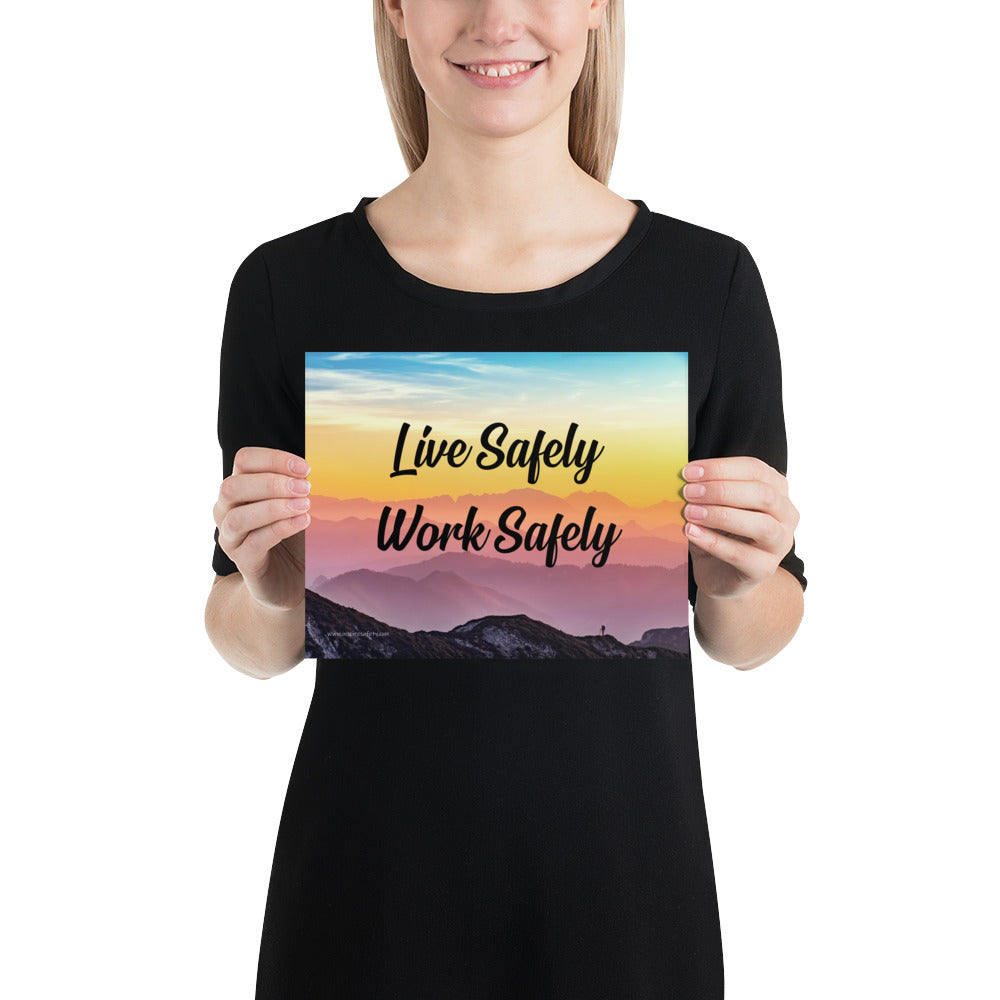 A safety poster showing a mountain range with a beautiful gradient in the sky of blue, yellow, and pink with the safety slogan "Live Safely Work Safely."