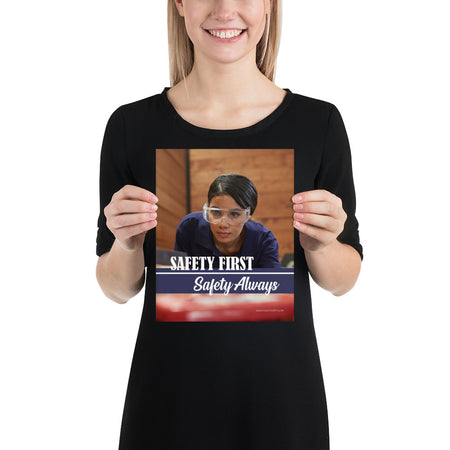 A safety poster showing a woman in safety glasses working in a woodshop with the slogan "Safety first, safety always" below her.