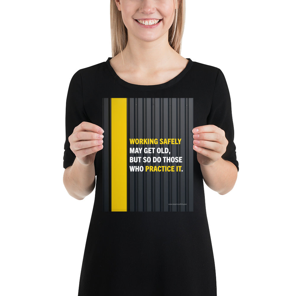 A construction safety poster showing a black metal wall with a yellow stripe with the slogan "Working safely may get old, but so do those who practice it."