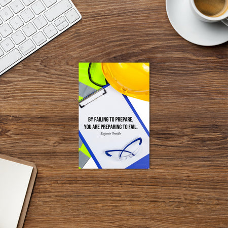 A safety print featuring a clipboard surrounded by a hard hat, safety glasses, and a reflective vest with a quote by Ben Franklin that says "By failing to prepare, you are preparing to fail."