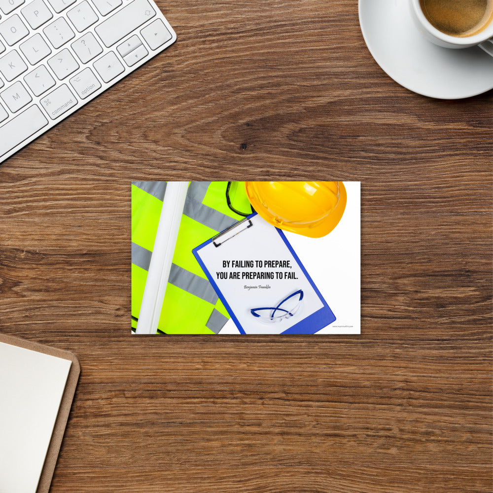 A safety print featuring a clipboard surrounded by a hard hat, safety glasses, and a reflective vest with a quote by Ben Franklin that says "By failing to prepare, you are preparing to fail."