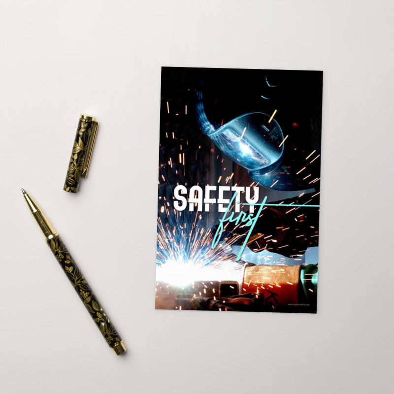 A safety print showing a close-up of a welder welding a pipe while wearing a welding hood with bright sparks flying all around with the slogan safety first.