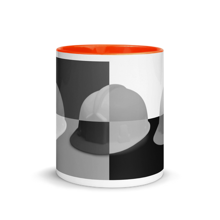 White ceramic mug with a bold hard hat pop art print in a black and grey colorway with orange color on the inside, the rim, and the handle.