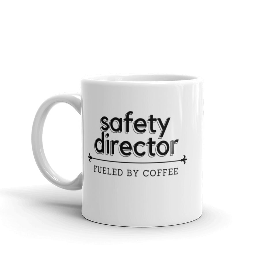 White ceramic mug with the phrase "Safety Director, fueled by coffee."