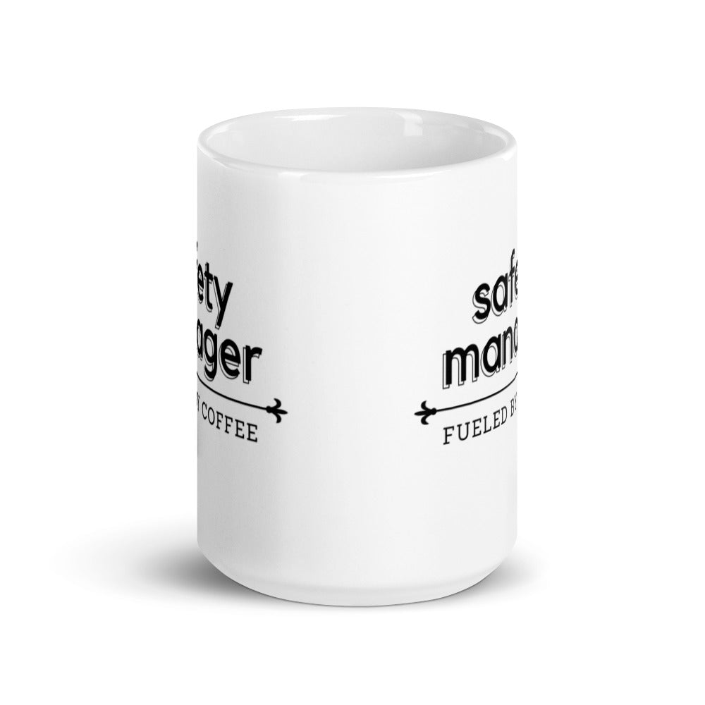White ceramic mug with the phrase "Safety Manager, fueled by coffee."