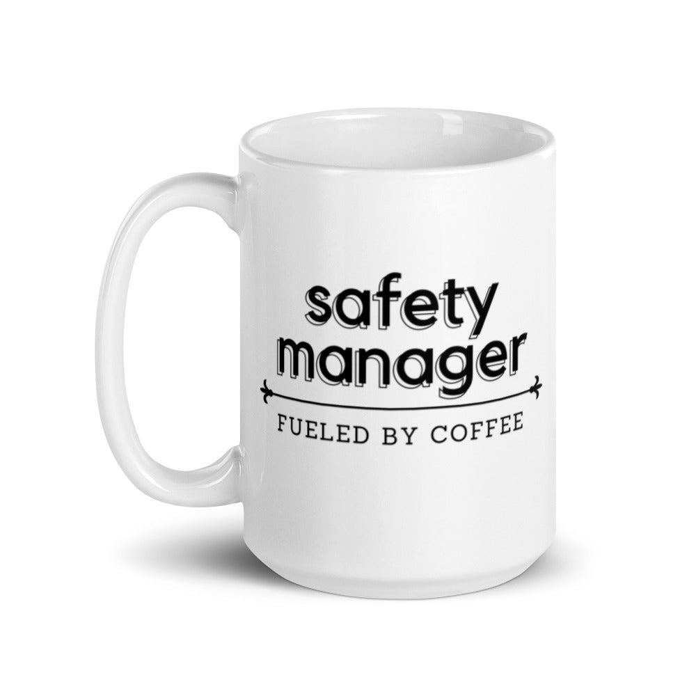 White ceramic mug with the phrase "Safety Manager, fueled by coffee."