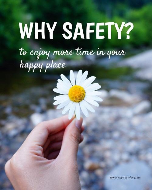 A workplace safety poster showing a close up of a hand holding a bright white daisy in the forest with the slogan why safety? to enjoy more time in your happy place.