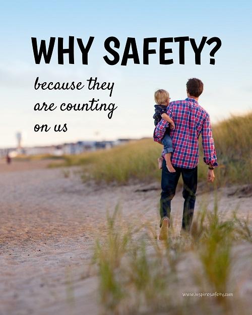 A workplace safety poster showing a man carrying his young child along the beach on a beautiful sunny day with the slogan why safety? because they are counting on us.