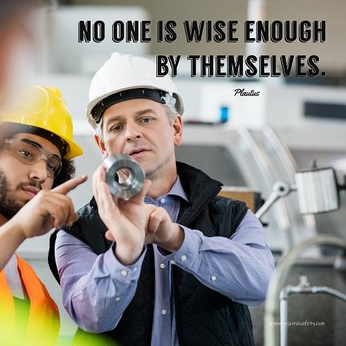 A workplace safety poster showing two workers in hardhats, reflective vests, and safety glasses collaborating together in a factory with the quote no one is wise enough by themselves by Plautus. 