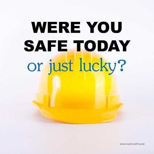 A workplace safety poster showing a yellow hard hat on a plain white background with the slogan were you safe today, or just lucky?