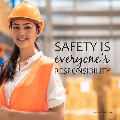 A workplace safety poster showing a young warehouse worker in a yellow hardhat and orange reflective vest holding a clipboard and smiling with the slogan safety is everyone's responsibility.