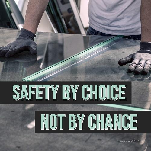 A workplace safety poster showing a close-up of a worker's hands grabbing panes of glass with gloves on with the slogan safety by choice not by chance.