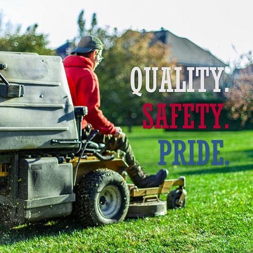 A workplace safety poster showing a man mowing a lawn on a sitting mower with the words quality, safety, pride in white, red, and blue, respectively. 