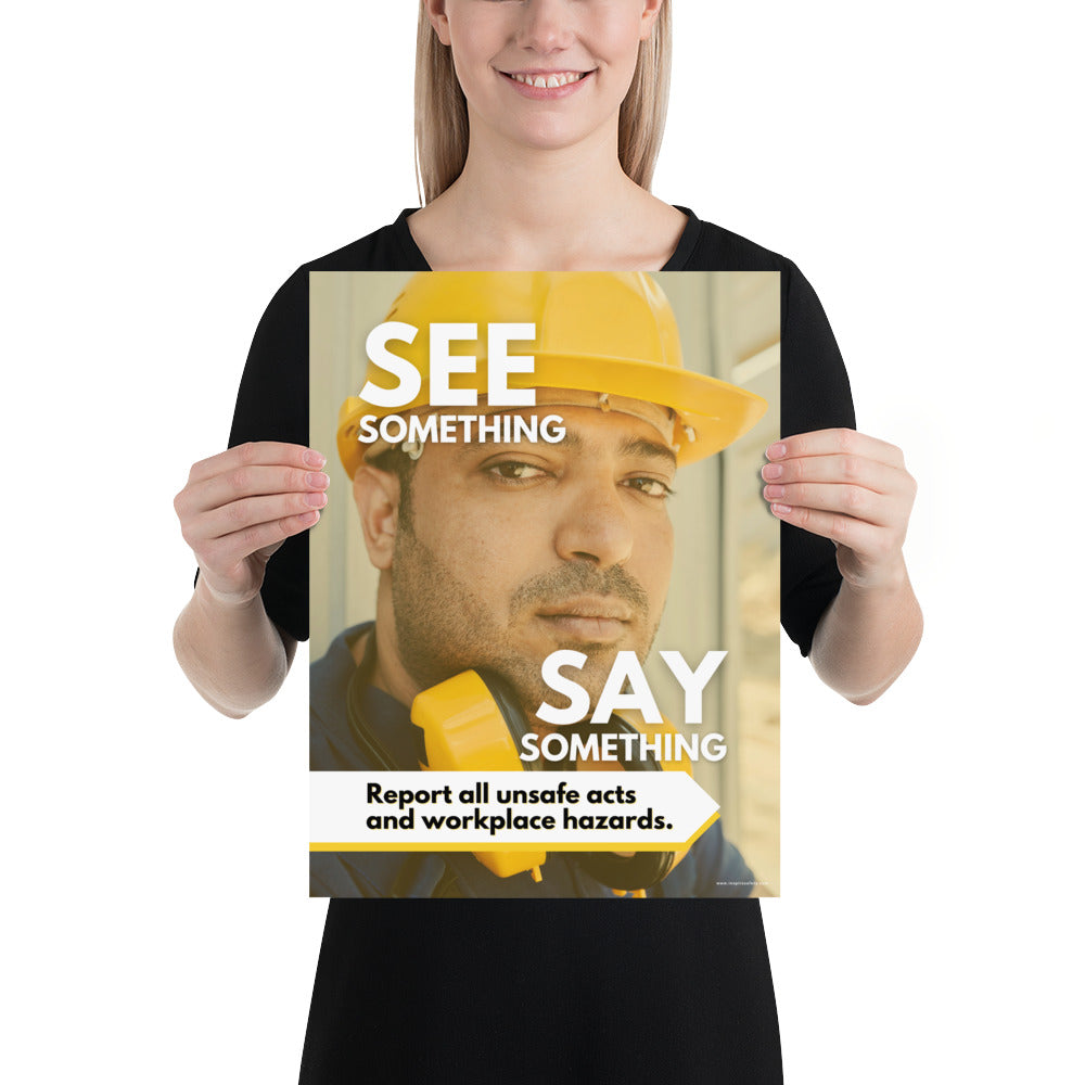 A workplace safety poster showing a solemn man's face wearing a hard hat with the words "See Something, Say Something" with a small banner at the bottom that says "Report all unsafe acts and workplace hazards."