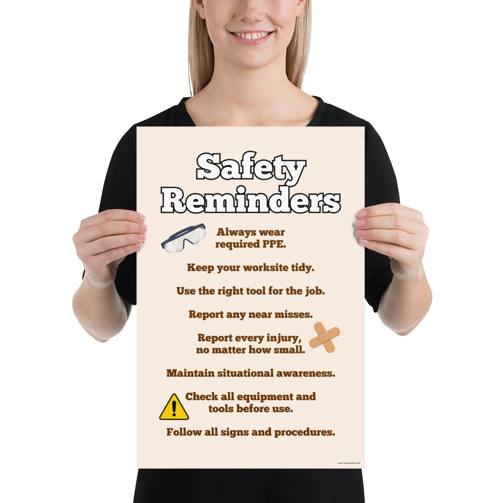 A workplace safety poster with a light tan background and large text saying "Safety Reminders" with a list underneath it of various workplace safety tips.