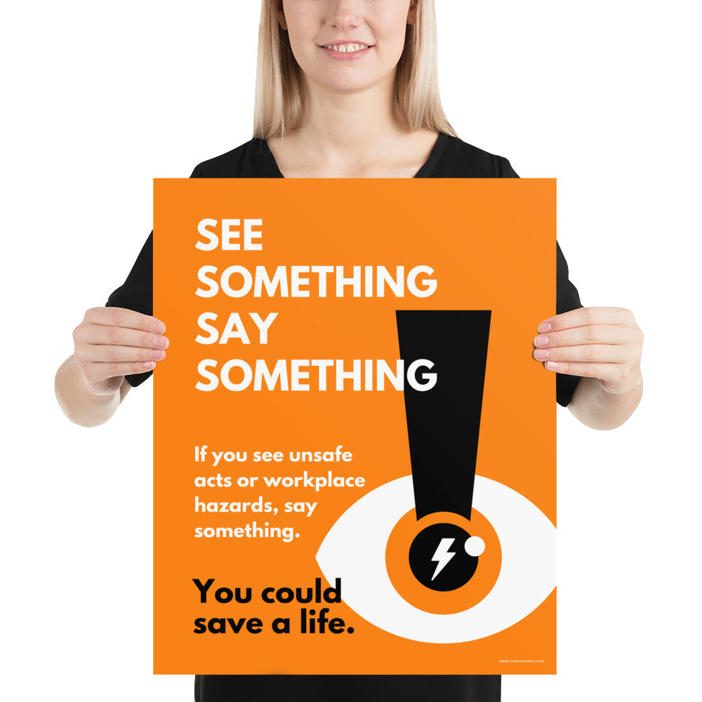 A workplace safety poster with a bright orange background an an eye with an exclamation point coming from the pupil and a lightning bolt in the middle of the pupil with text that says "See Something Say Something" in bold lettering with the words "If you see unsafe acts or workplace hazards, say something. You could save a life."